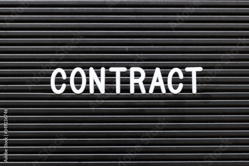 Black felt board with white alphabet in word contract background