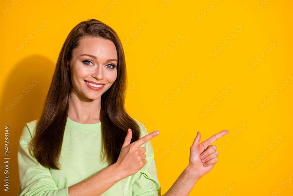 Photo of attractive lady good mood direct fingers side empty space showing novelty product wear green cropped sweatshirt isolated vivid bright yellow color background Photo of attractive lady good mood direct fingers side empty space showing novelty product wear green cropped sweatshirt isolated vivid bright yellow color background