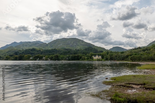 Shore of the Loch Shiel lake in Glenfinnan, Scotland with a house in the background