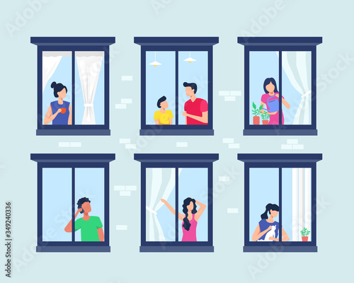 Apartment building with people in open window photo