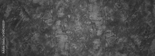 Dark gray wall with concrete texture and vignette as a background or wallpaper for studio display your products.
