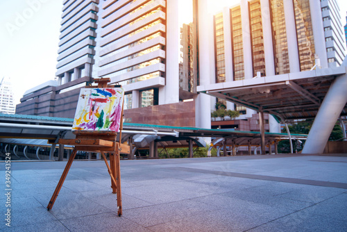 Abstract art paints on easel in the city
