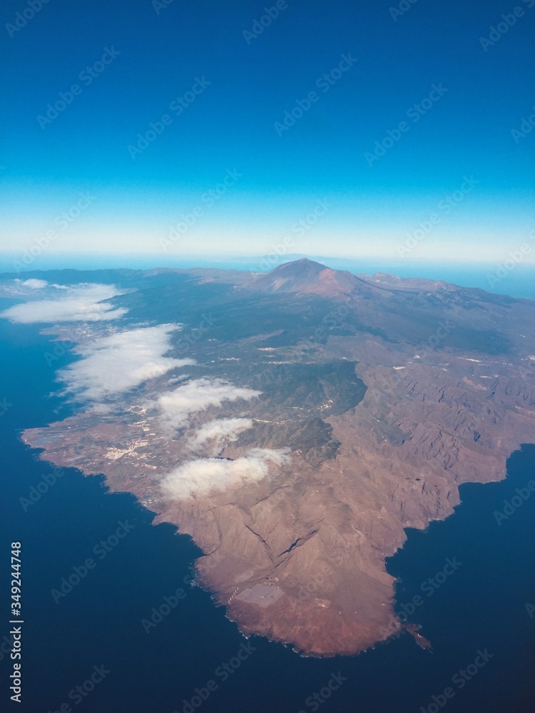 Tenerife landscape and coast from the air with vivid blue skies and curvature of the earth