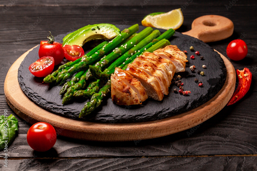 Ketogenic diet breakfast. Chicken grilled fillet with salad fresh tomatoes, asparagus and avocado. Healthy food, diet menu. Long format with copy space Ketogenic diet breakfast. Chicken grilled fillet with salad fresh tomatoes, asparagus and avocado. Healthy food, diet menu. Long format with copy space