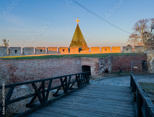 Cross and roof of the bell tower of the Serbian Orthodox Church of the Holy Mother of God (Crkva Ruzica) located in Kalemegdan fortress under the brick wall of Zindan gate. photo