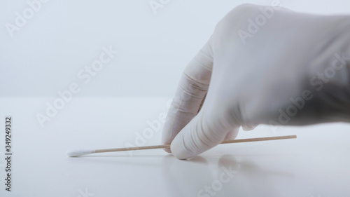 Placeing a swab for covid testing on a white surface.