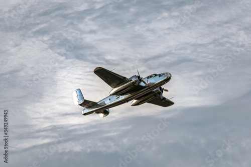 Fototapeta Naklejka Na Ścianę i Meble -  Vintage bomber airplane with dramatic cloudscape