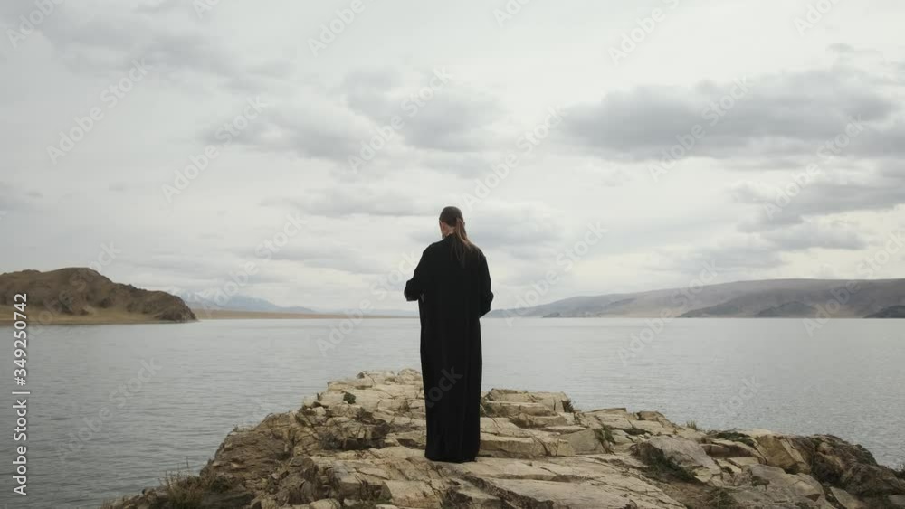 beautiful girl traveler on edge of cliff at top of mountain.look around, back view, front View of a large lake.woman enjoy adventure mountain scenery. beautiful girl traveler on edge of cliff at top of mountain.look around, back view, front View of a large lake.woman enjoy adventure mountain scenery.