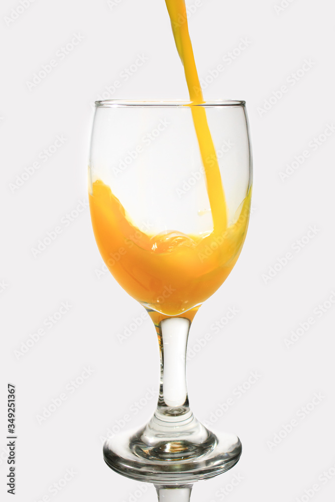 Pour the orange juice into the glass.