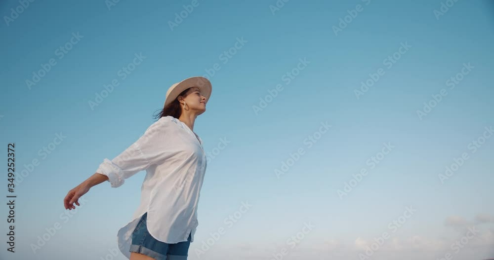 Beautiful woman on a background of sky. Shot on Black Magic Cinema Camera Beautiful woman on a background of sky. Shot on Black Magic Cinema Camera