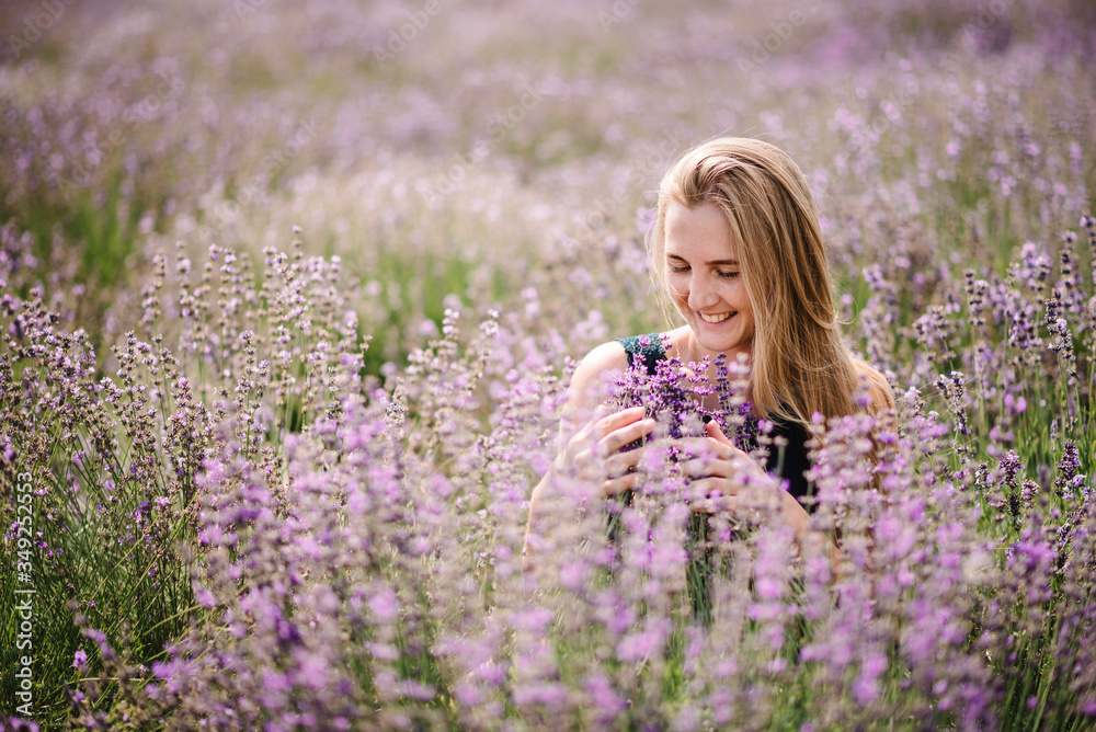 Beautiful girl in dress in purple lavender field. Beautiful woman walk on the lavender field. Girl collect lavender. Enjoy the floral glade, summer nature. Natural cosmetics and eco makeup concept. Beautiful girl in dress in purple lavender field. Beautiful woman walk on the lavender field. Girl collect lavender. Enjoy the floral glade, summer nature. Natural cosmetics and eco makeup concept.
