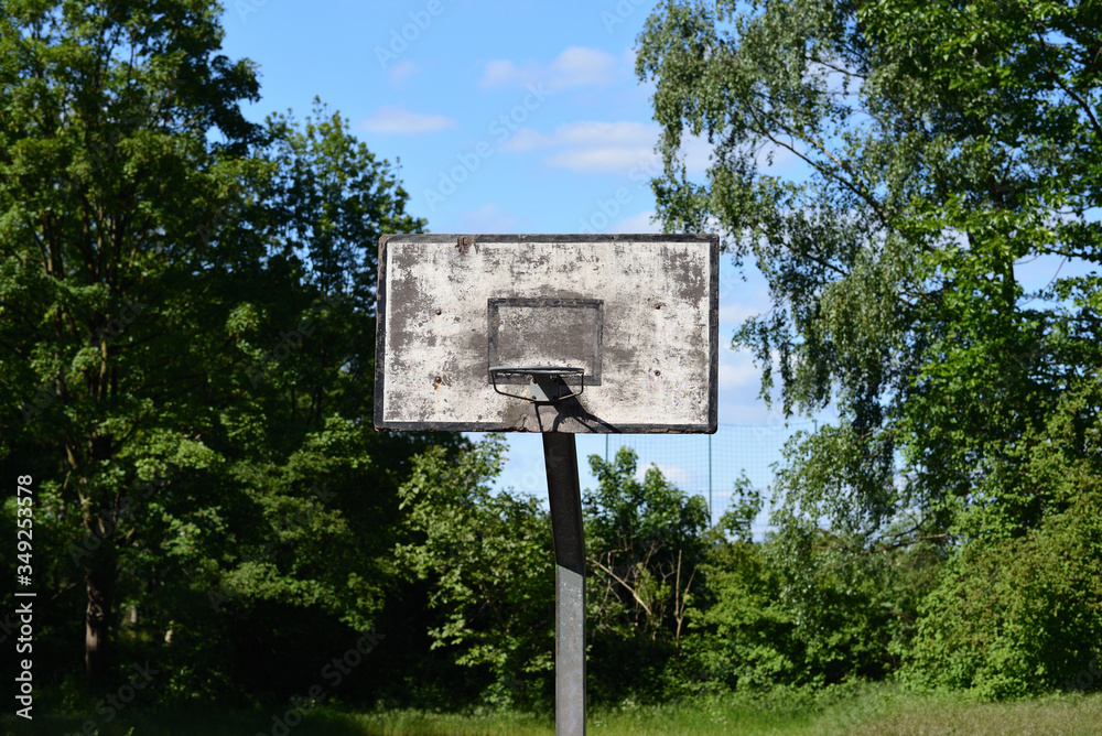Old dirty basketball ring and blue sky in the background