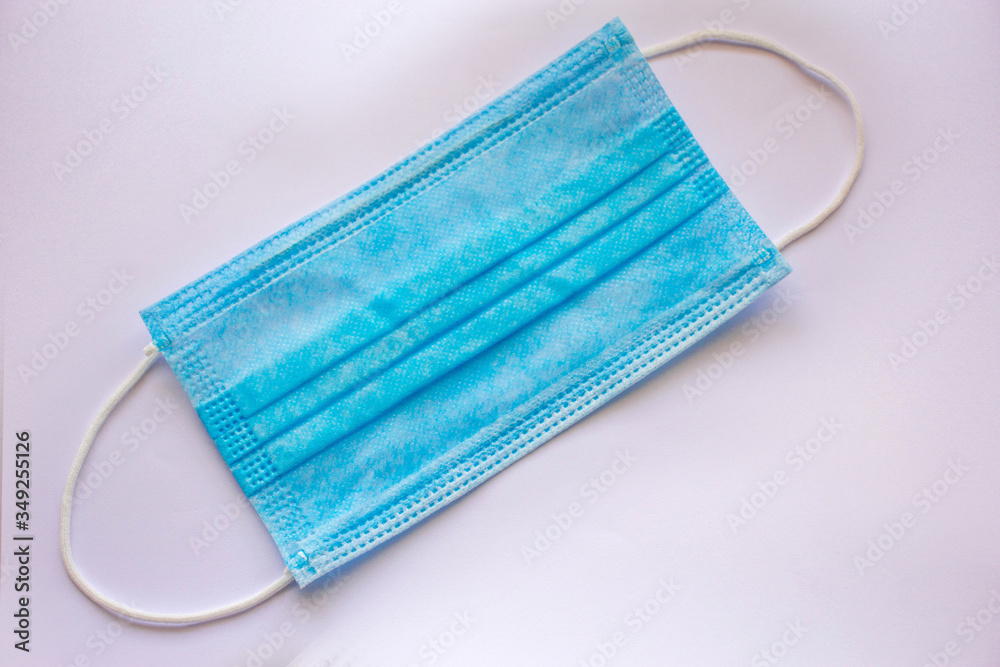 Medical mask isolated on gray background. Typical 3-ply surgical mask to cover the mouth and nose. Protective face mask on Gray background. Procedure mask from bacteria. Medical mask isolated on gray background. Typical 3-ply surgical mask to cover the mouth and nose. Protective face mask on Gray background. Procedure mask from bacteria.