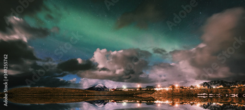 The northern lights that appear in Iceland's wintertime appear among the clouds. Fantastic picture. Reflection ground in lake