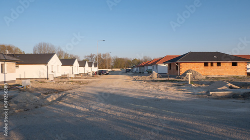 Newly built houses under construction. The newly built street is not yet paved.