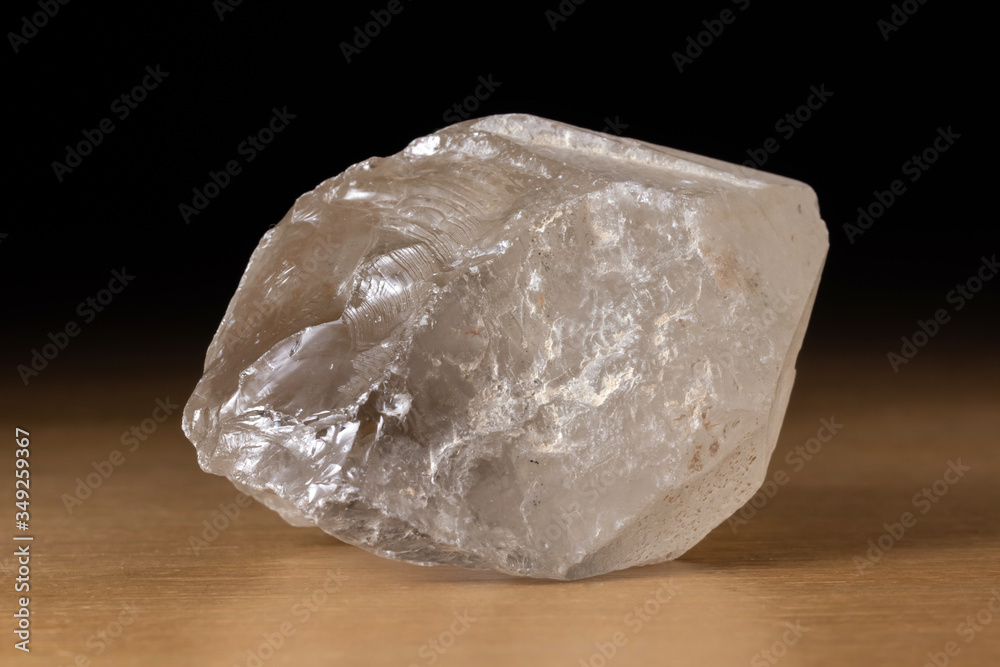 Translucent smoky quartz mineral from Brazil over a wooden table Translucent smoky quartz mineral from Brazil over a wooden table