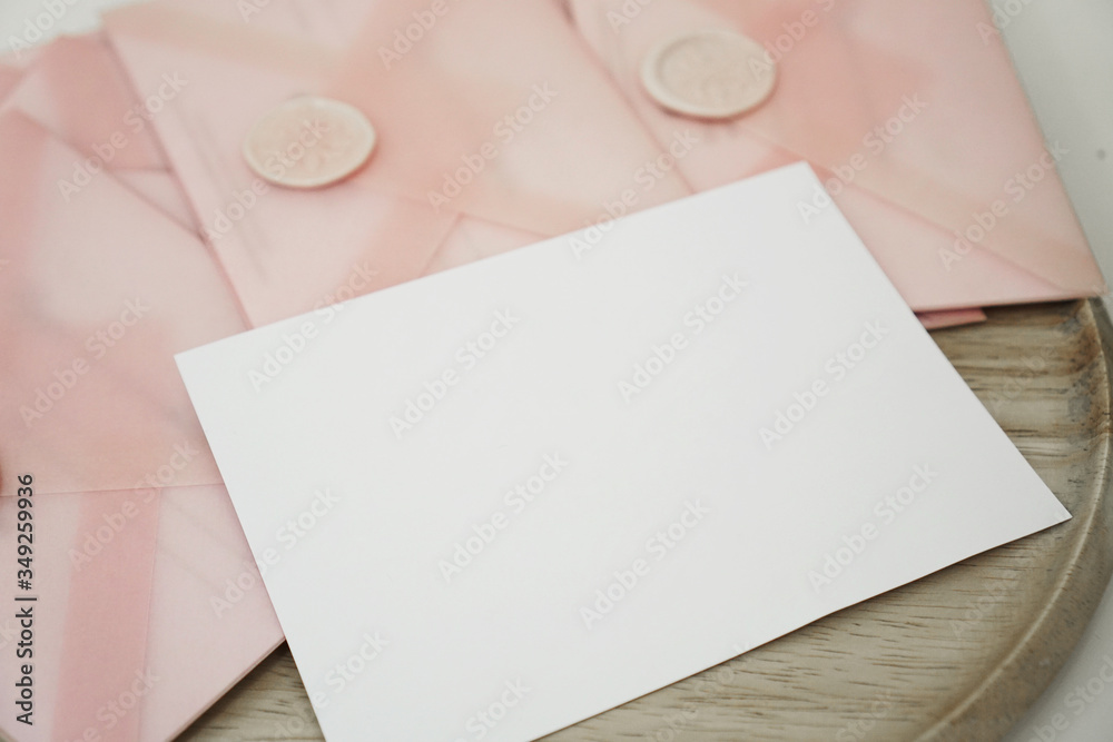 Fototapeta premium Gift certificates in a pink envelope. Wedding invitation or Valentine's Day cards - Mocap - place for text