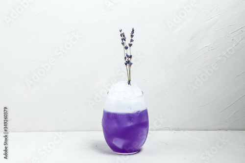 Unusual purple lavender foam cocktail in a  glass photo