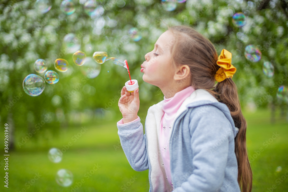 Beautiful little blonde girl, has happy fun cheerful smiling face, soap bubble blower. Beautiful little blonde girl, has happy fun cheerful smiling face, soap bubble blower.