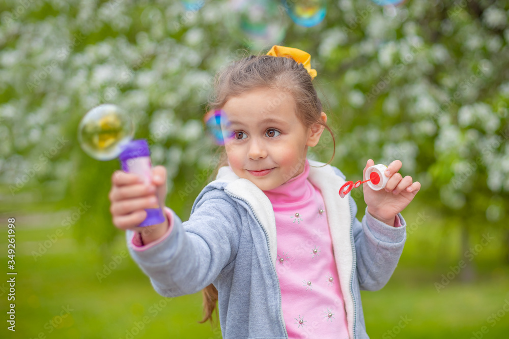 Beautiful little blonde girl, has happy fun cheerful smiling face, soap bubble blower. Beautiful little blonde girl, has happy fun cheerful smiling face, soap bubble blower.