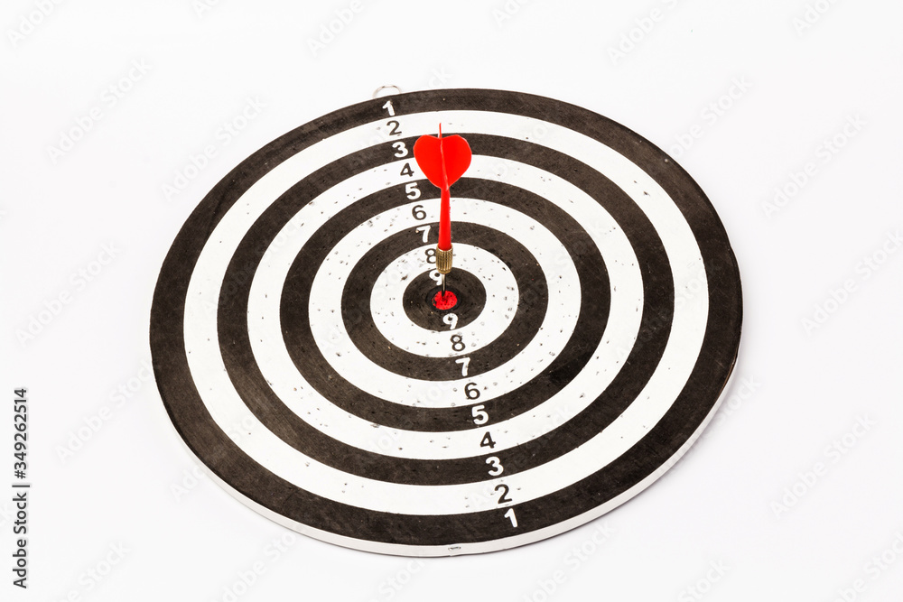 Dartboard with darts on white background, closeup. Purpose concept