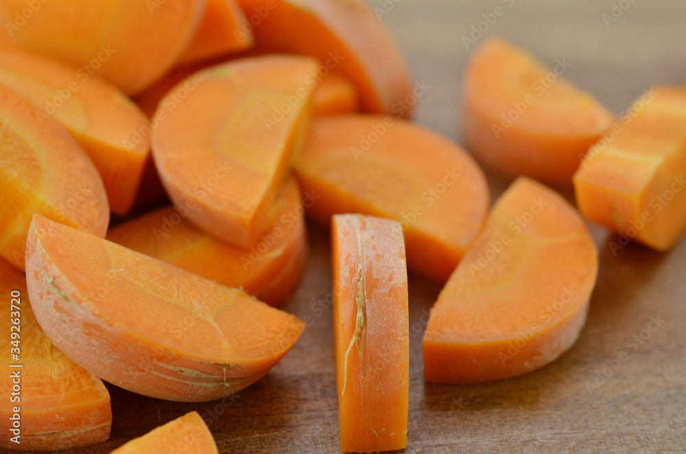 Cut carrots thick on wooden background Cut carrots thick on wooden background
