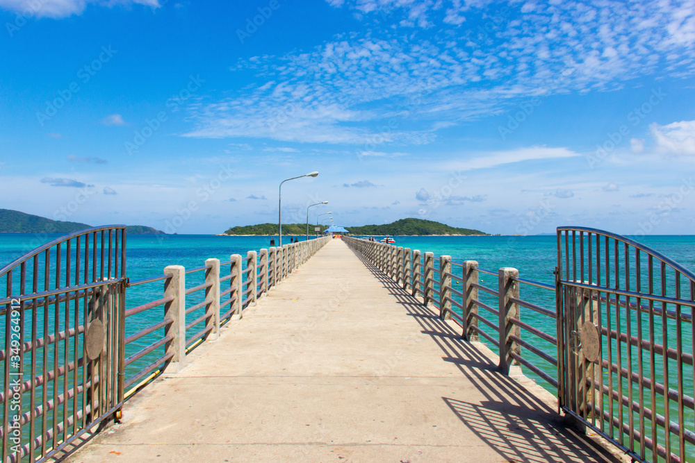 Perspective Concrete walkway in the sea to Boat landing , Ocean horizon and white clouds on blue sky background, Bright travel summer island landscape. - Image