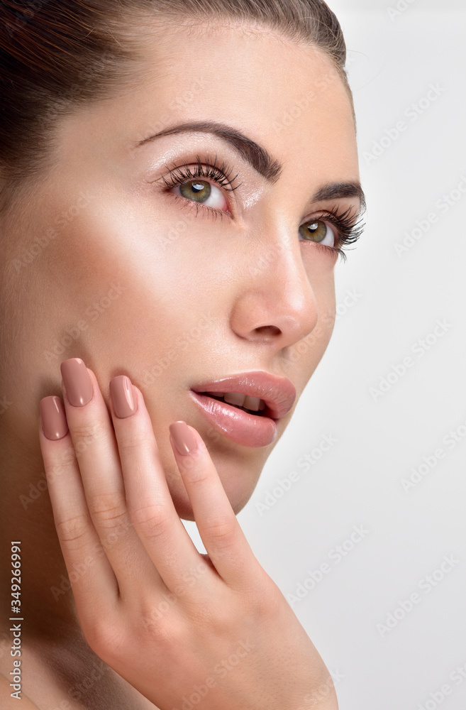 Beautiful Young Woman with Clean Fresh Skin. Close up Portrait. Fashion Model Girl Face. Perfect Skin. Professional Makeup. Fashion shiny highlighter on skin, sexy gloss lips. Perfect manicure. Beautiful Young Woman with Clean Fresh Skin. Close up Portrait. Fashion Model Girl Face. Perfect Skin. Professional Makeup. Fashion shiny highlighter on skin, sexy gloss lips. Perfect manicure.