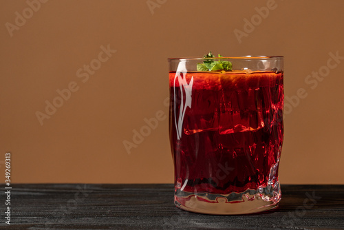 Glass of rum on the wooden table, Cuba Libre or long island iced tea cocktail with strong drinks and sliced orange