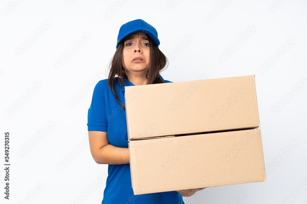 Young delivery brunette girl over isolated white background freezing Young delivery brunette girl over isolated white background freezing