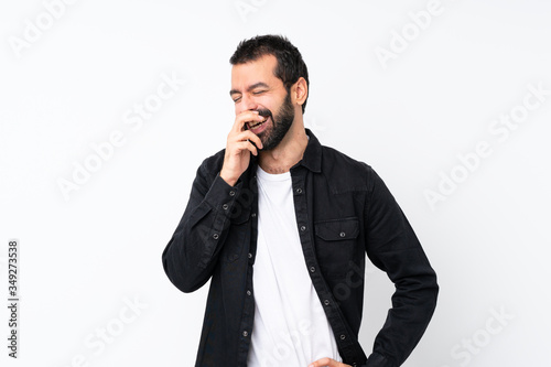 Young man with beard over isolated white background smiling a lot © luismolinero