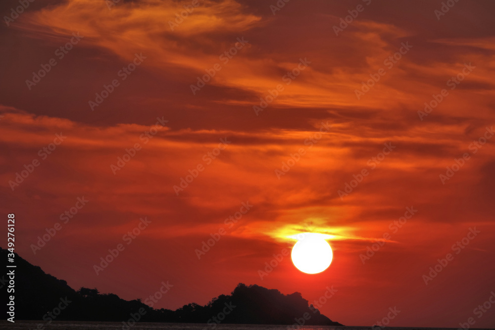 sunset orange sky black silhouette of a mountain