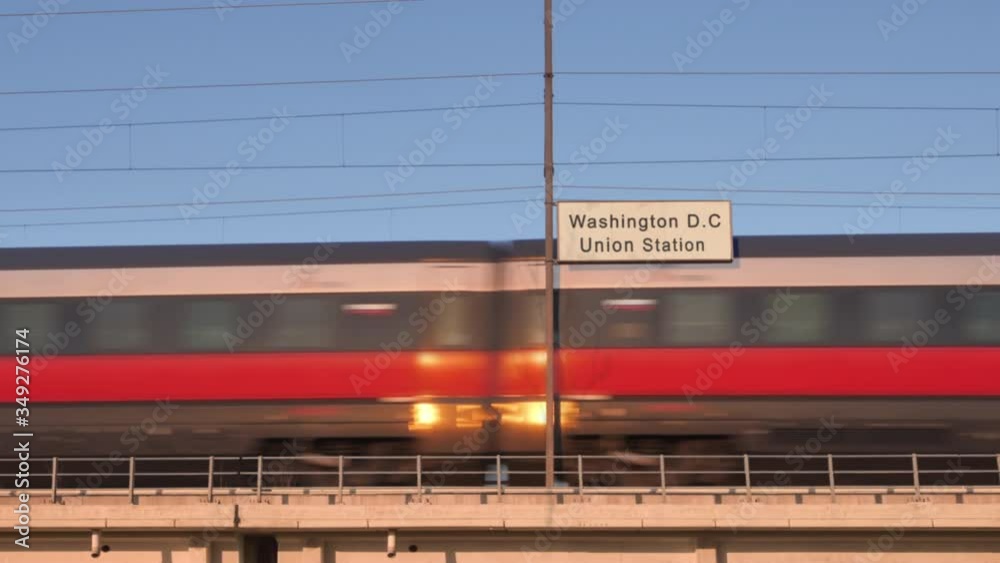washington railway billboard train passing behind train station signboard