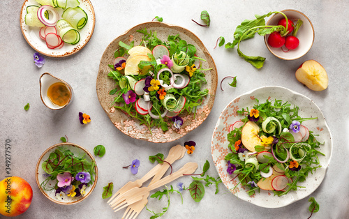 Quadro su tela Delicious summer salad with edible flowers, vegetables, fruit, microgreens and cheese