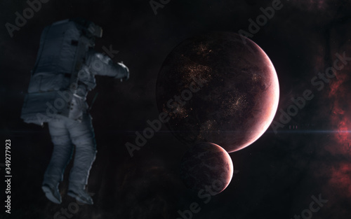 Astronaut on background of inhabited planets in red light. Deep space. Science fiction. Elements of this image furnished by NASA