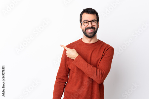 Fotobehang Caucasian handsome man with beard over isolated white background pointing to the