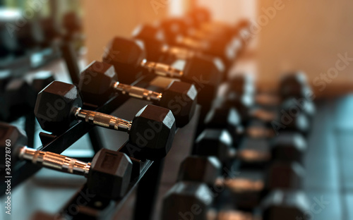 Rows of dumbbells in the gym with sunset light