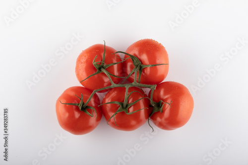 Ripe Fresh Cherry Tomatoes on Branch Isolated on White Background