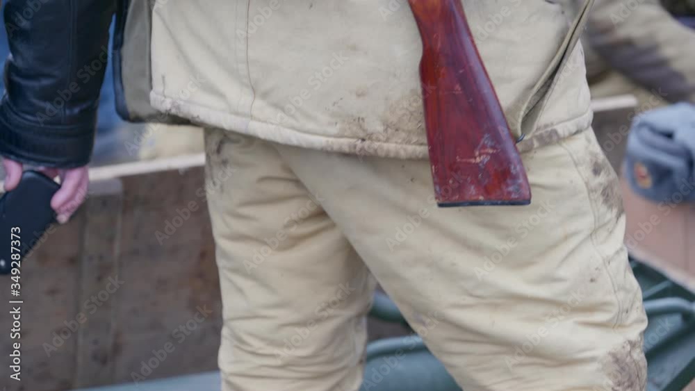 A Russian soldier standing with weapon and mobile radio set