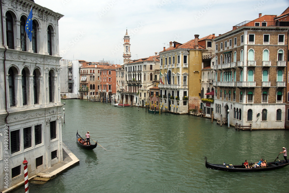 View from Rialto bridge.  City landscape with grand canal, buildings and gondolas.