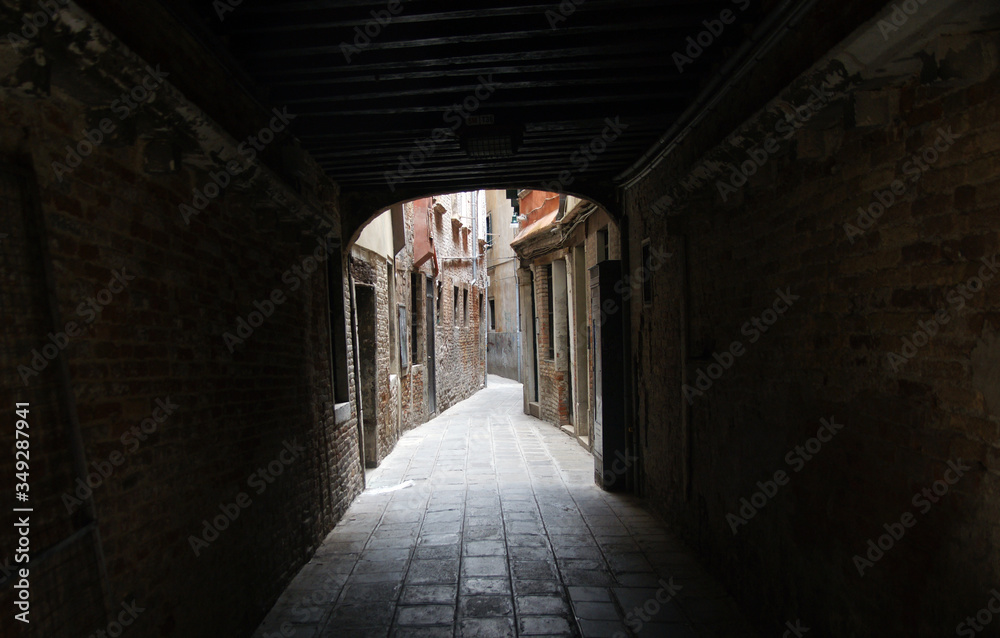 Photo of the tunnel in the street in Venice with historical facades.