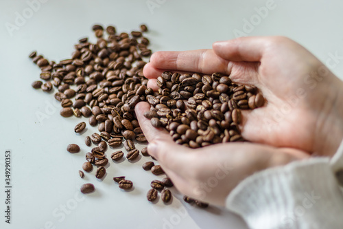 Young girl holding coffee beans...