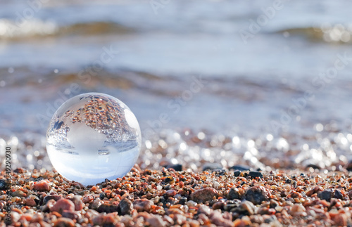 Glass gobe sphere on the sea as concept photo