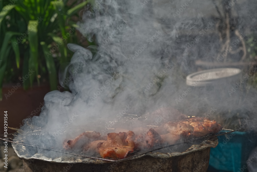 Chicken stick set with smoke on a charcoal stove Chicken stick set with smoke on a charcoal stove