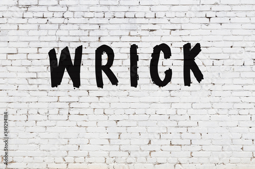 Word wrick painted on white brick wall photo