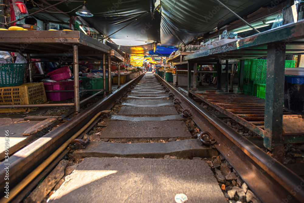 Thailand, Samut Songkhrami, Mae Klong railway market also called Siang Tai. Tourists walk along the train tracks and make purchases from local sellers. Pop place among tourists from all over the world