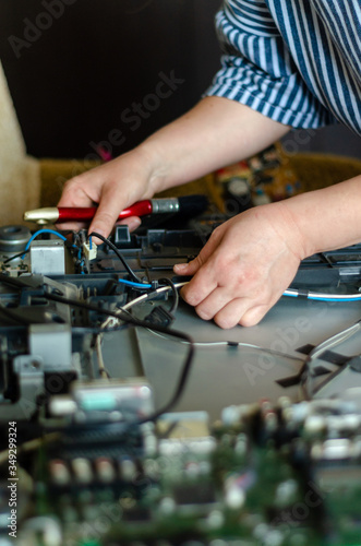 Close up of a woman hands repairing computer.