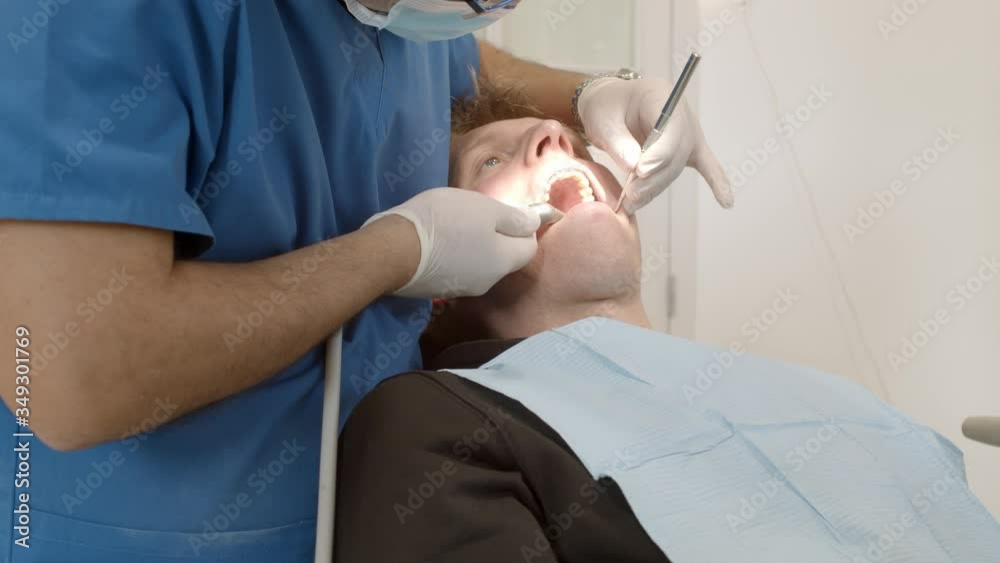 Dental clinic. Doctor dentist treats teeth to the patient in the dental clinic. Dentistry and orthodontist. Dental treatment and bite correction. Dental clinic. Doctor dentist treats teeth to the patient in the dental clinic. Dentistry and orthodontist. Dental treatment and bite correction.