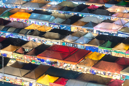 Bangkok, Thailand, Top view of Train Night Market Ratchada (Talad Rot Fai) flea market with plenty of shops with colorful canvas and amazing pattern of roofs near MRT line