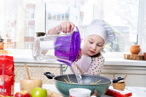 Cheerful cook makes pasta pasta